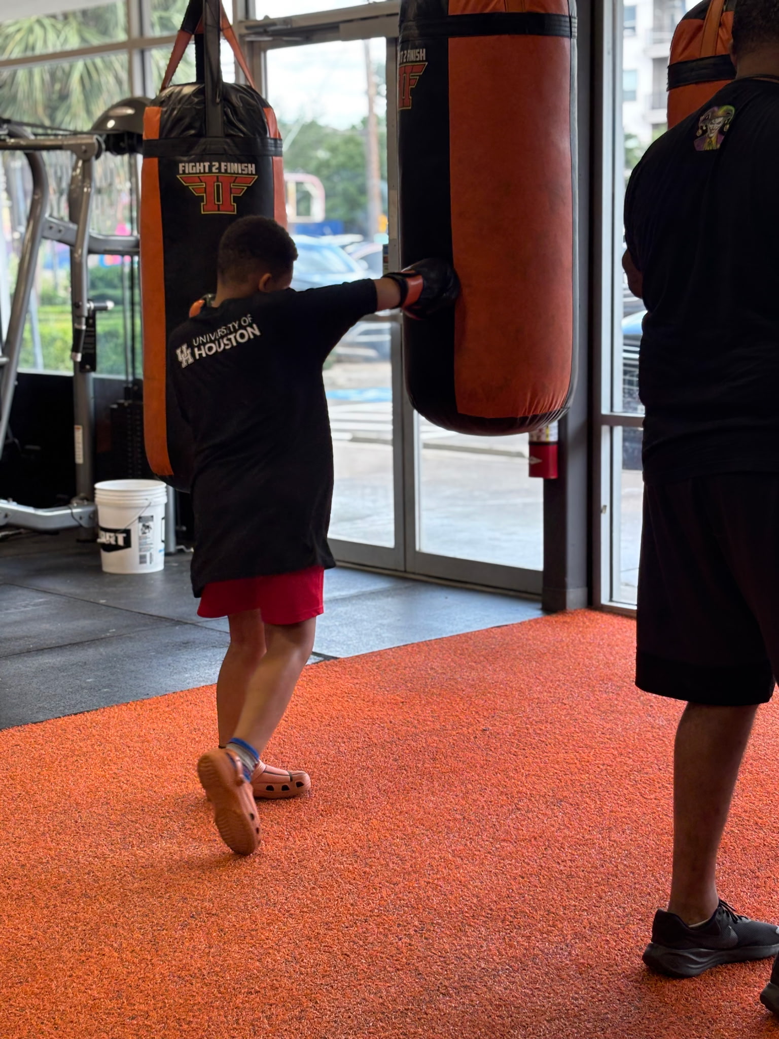 Kid striking boxing heavy bag